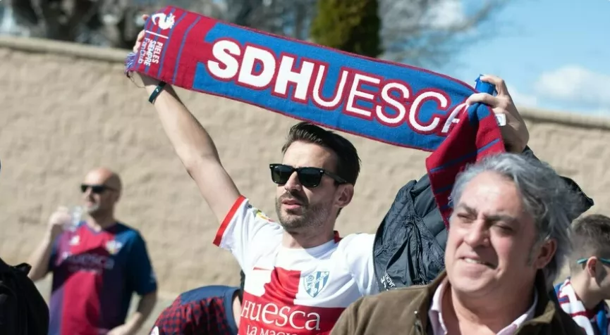 Un aficionado del Huesca levanta una bufanda. Un aficionado del Huesca levanta una bufanda.