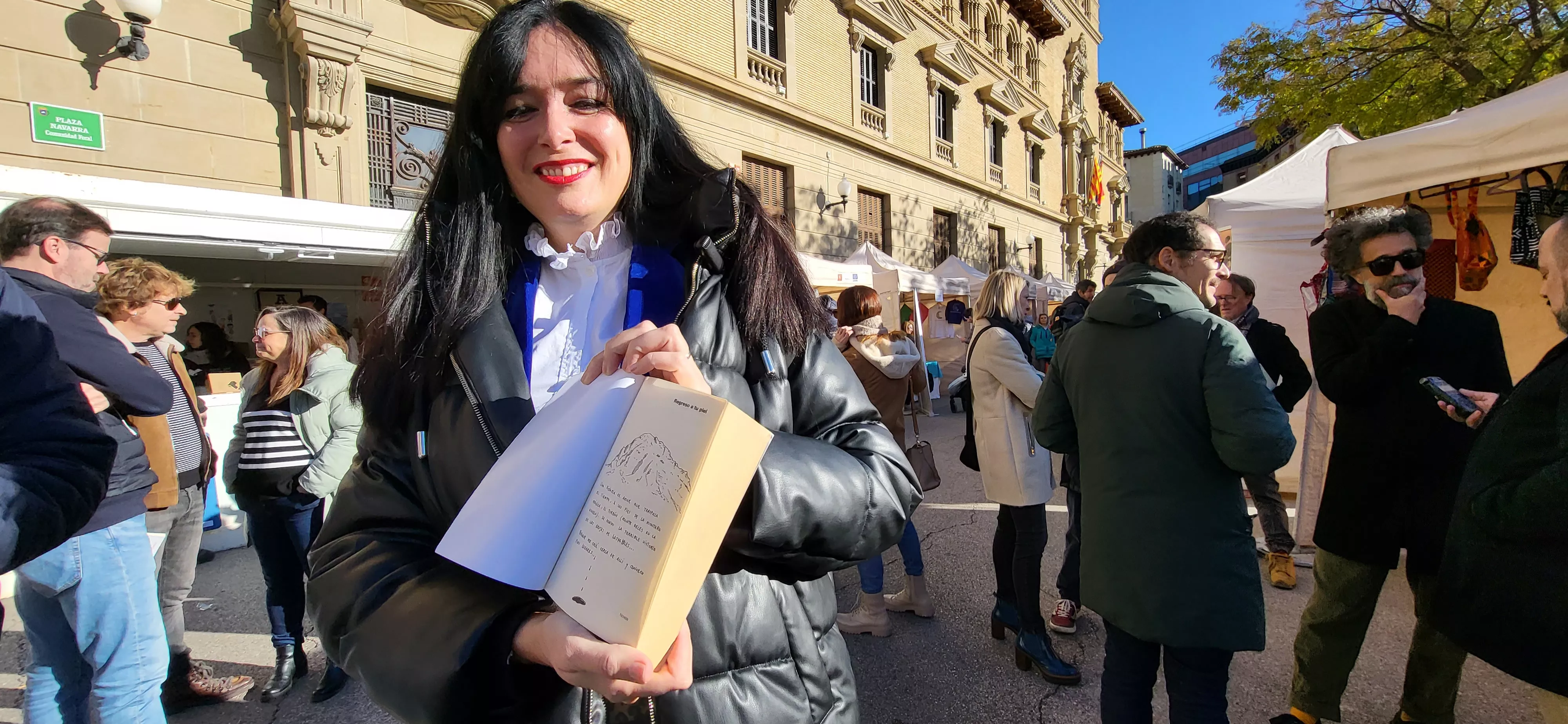 La alcaldesa de Huesca muestra la dedicatoria del libro que le ha tocado. Mercedes Manterola