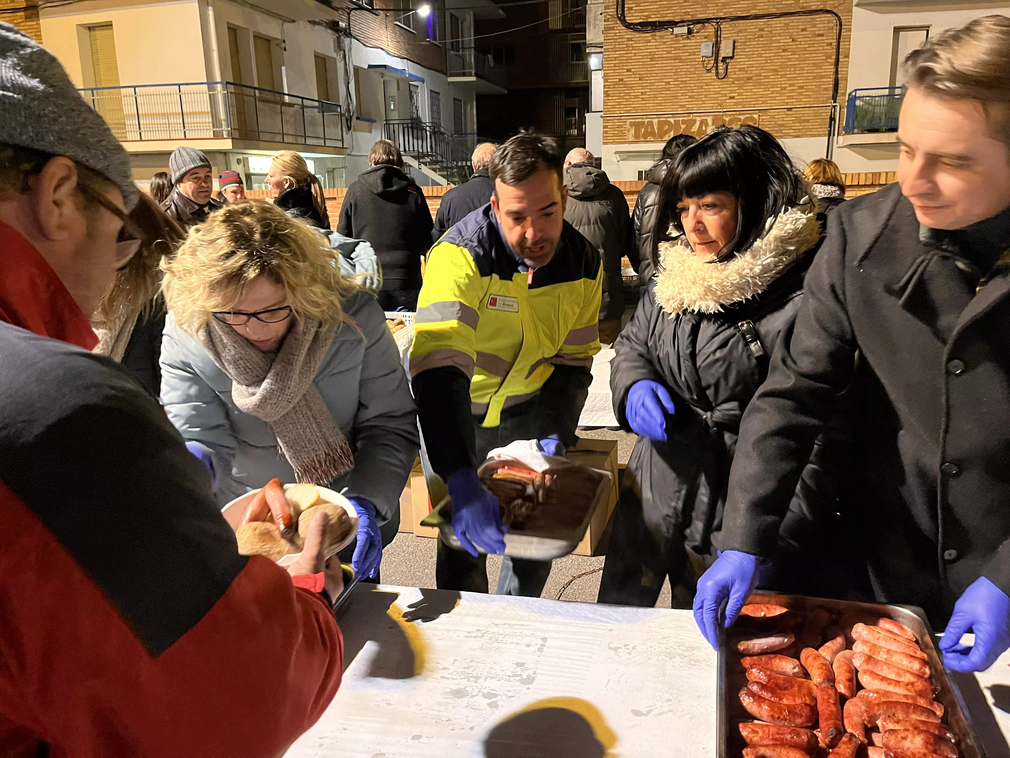 Reparto de patatas y longaniza. Foto Mercedes Manterola