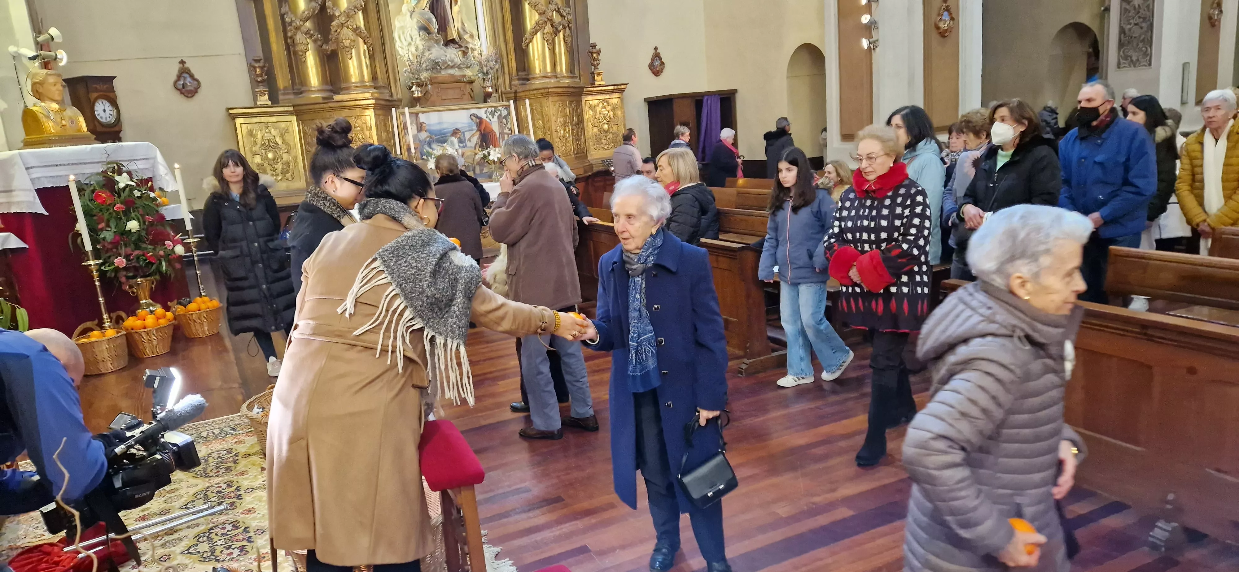 Reparto de naranjas en la Iglesia de San Vicente. Foto Myriam Martínez 