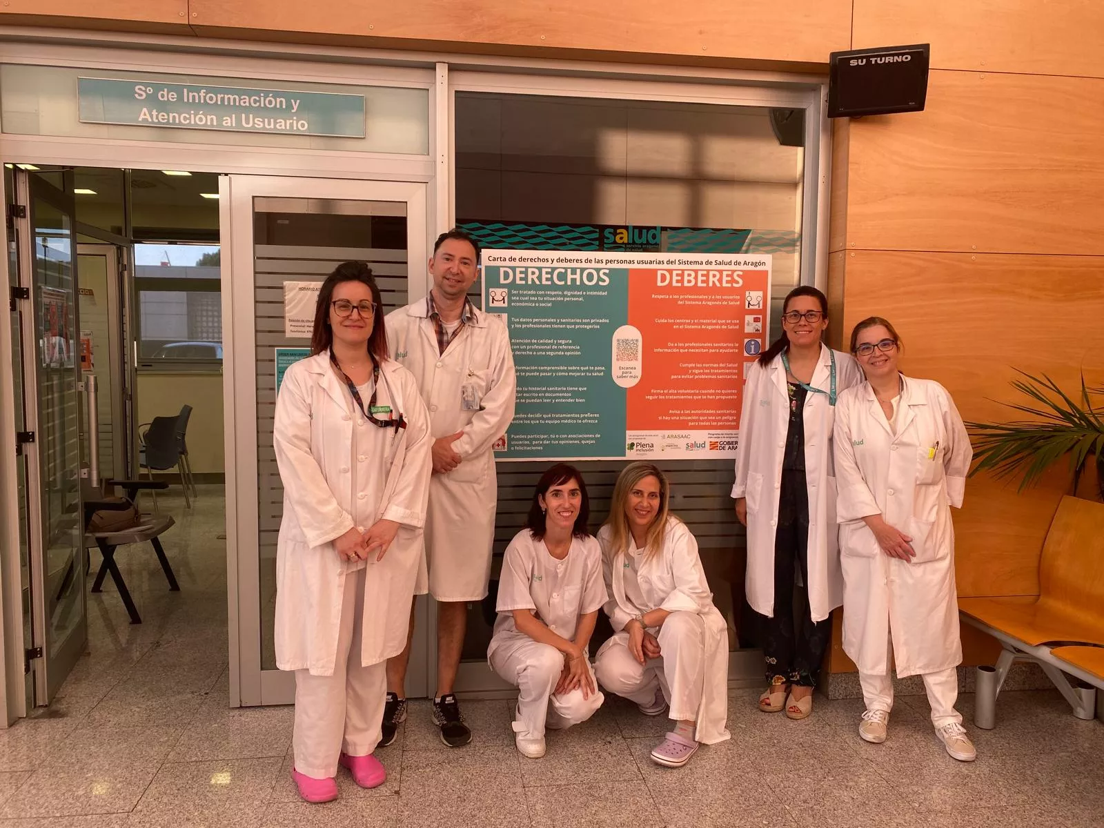 Trabajadores del Servicio de Información y Atención al Usuario del Miguel Servet de Zaragoza con la Carta de Derechos y Deberes