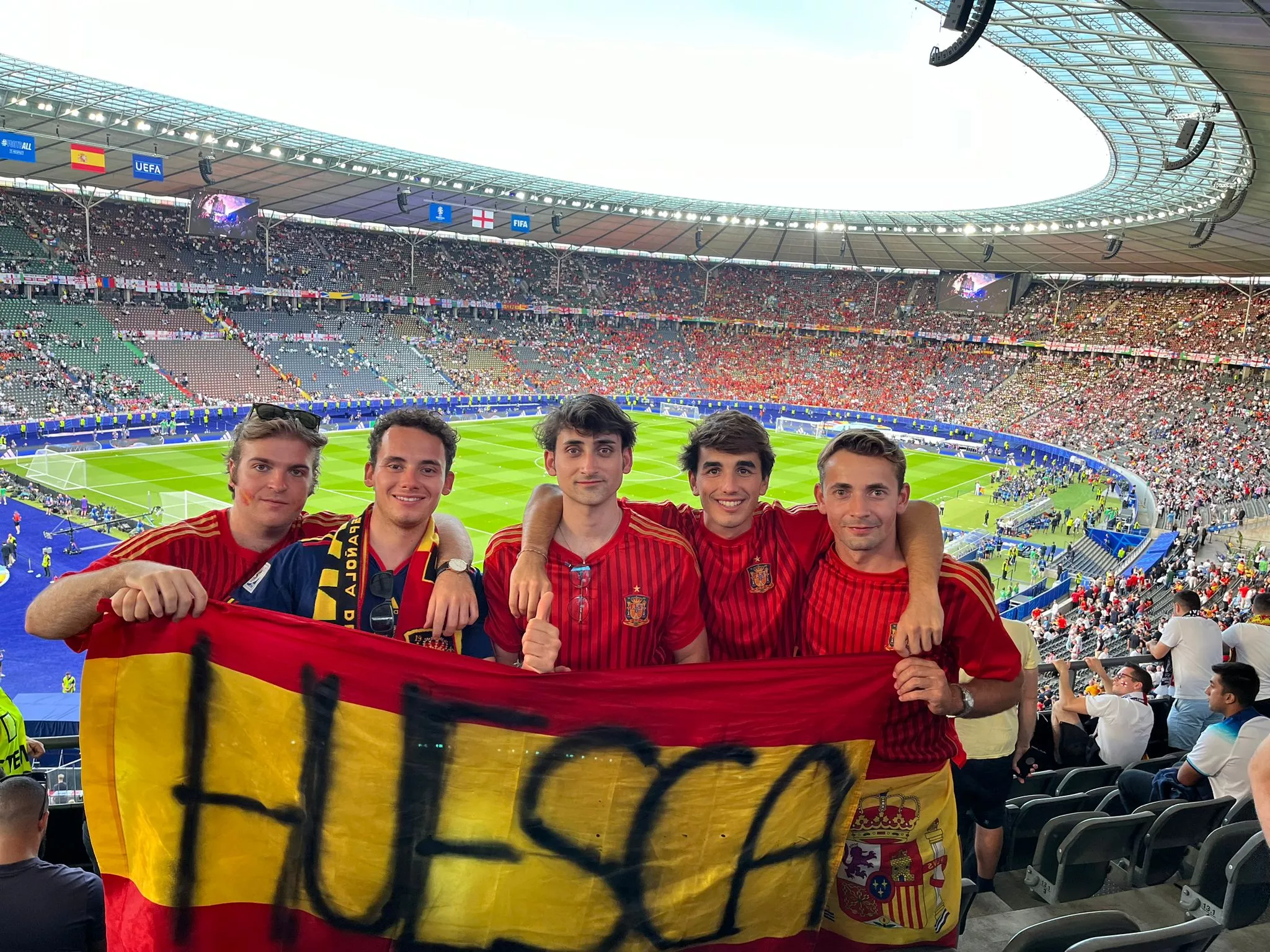 Diego Tebas, Nico Pérez, Santos Santolaria, Rodrigo Redal y Antonio Gayán, con la bandera española, en el Olímpico de Berlín. Un trocito de Huesca, presente en la final de la Eurocopa: "Cuando empataron nos cayeron muchos litros de cerveza".