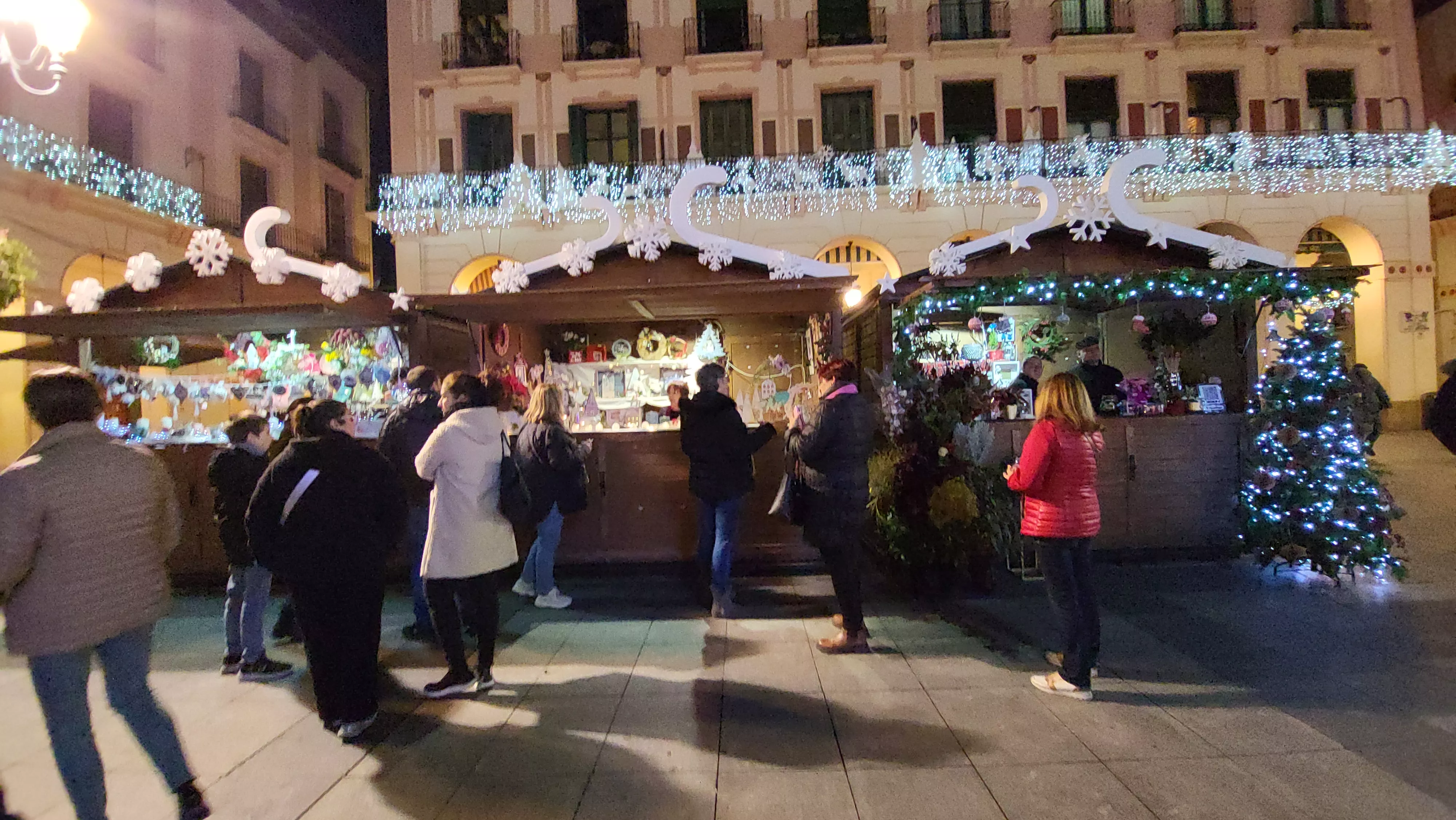 Reparto de poncho en el Mercado Local de Navidad de Huesca.