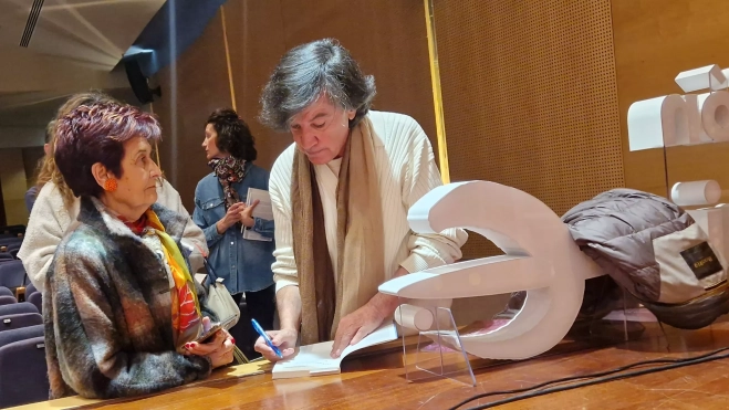 López-Otín, firmando ejemplares antes de que se llenara la sala. Foto Myriam Martínez
