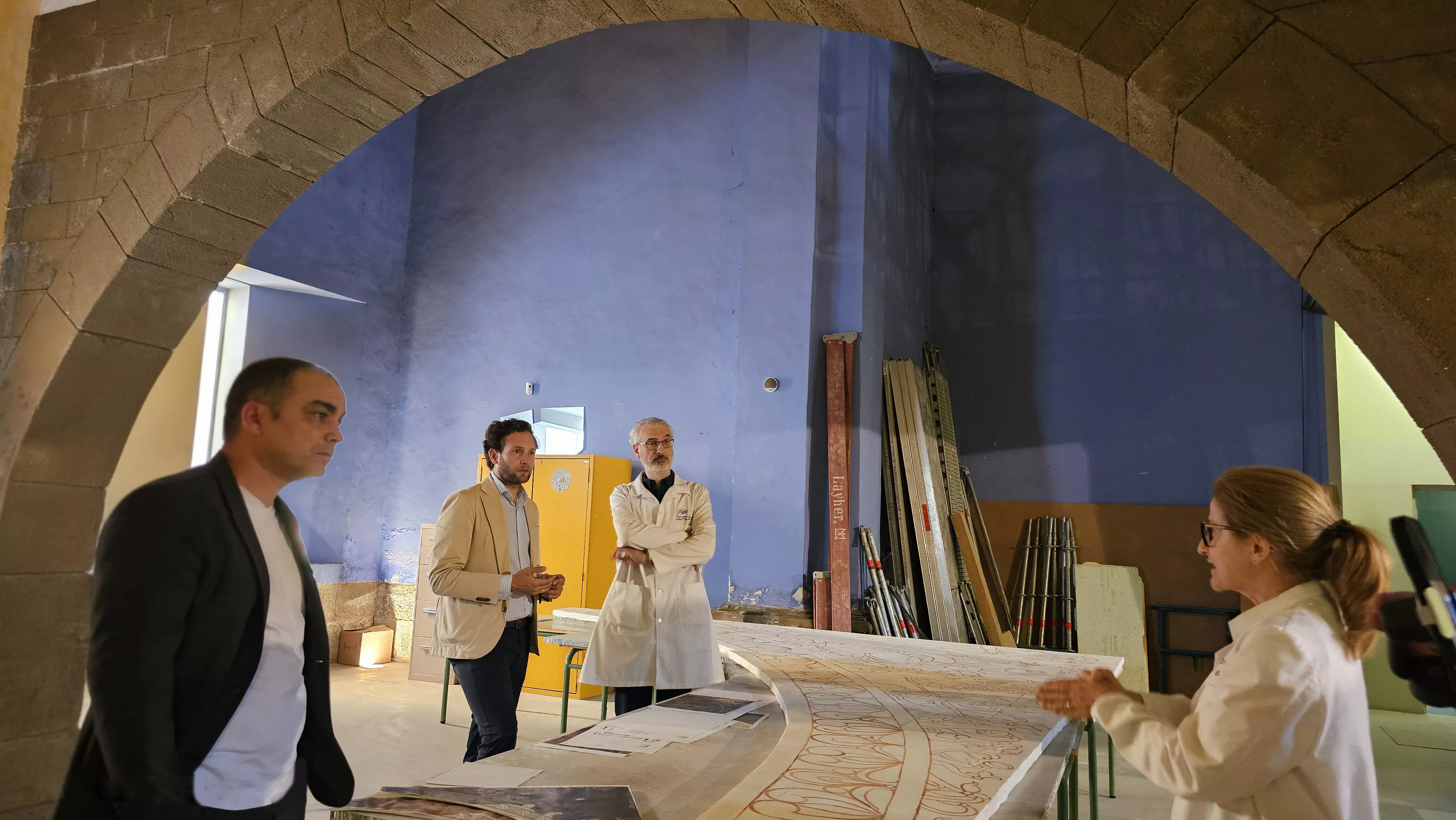 Carlos Sampériz, Isaac Claver e Ignacio Mustienes escuchan las explicaciones de la restauradora