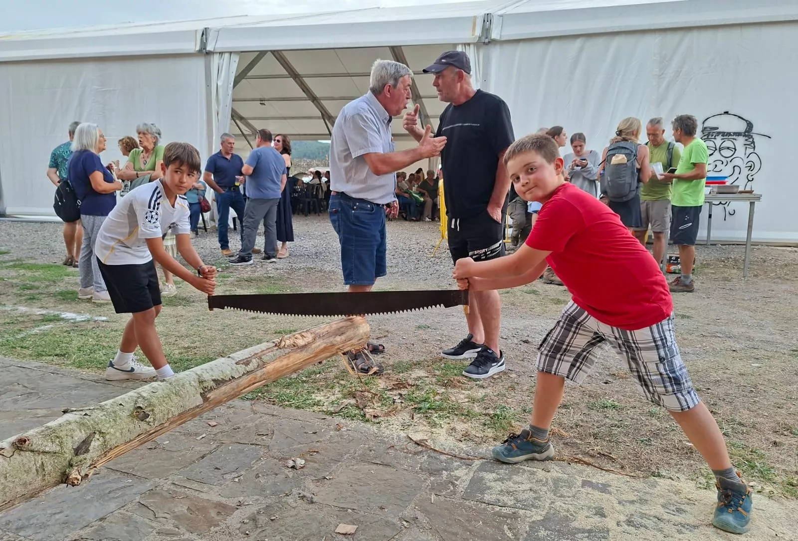 Los pequeños también participan en el concurso de aserrado de troncos.