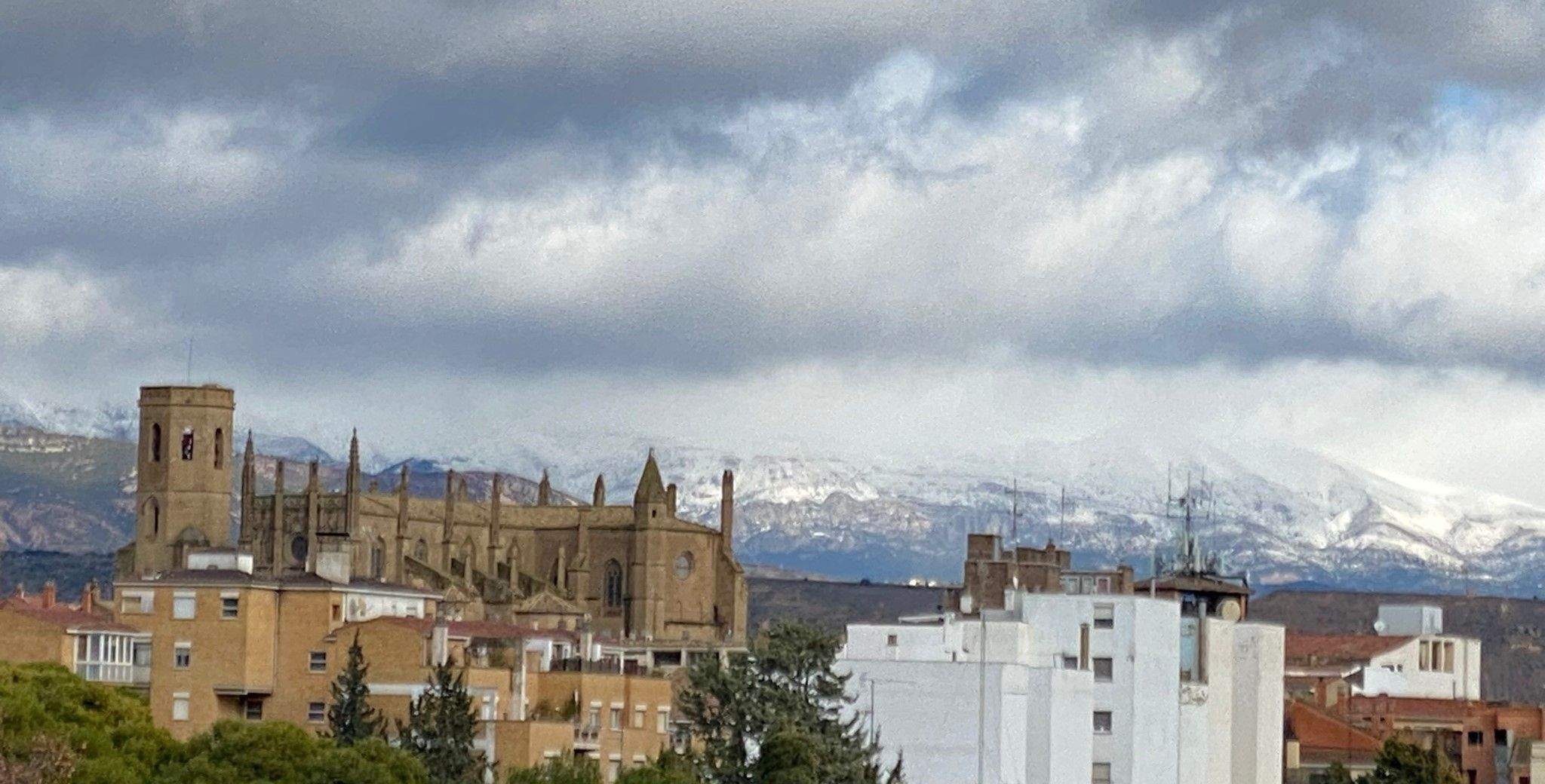 Imagen desde Huesca de la catedral con la sierra de Guara al fondo nevada