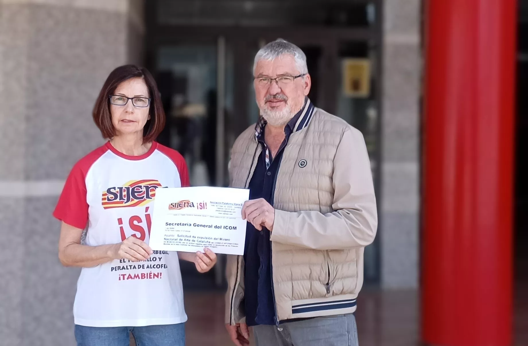  Cati Torres y Salvador Ariste muestran la carta al  Consejo Internacional de Museos ante la oficina de Correos de Sariñena.