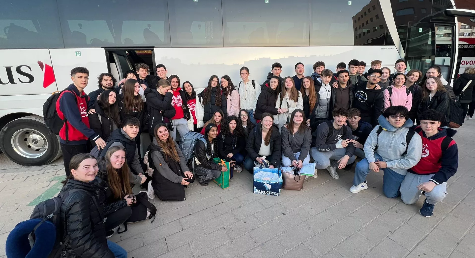 Los alumnos del colegio Santa Ana de Huesca y de Estados Unidos en la estación de autobuses de Huesca.
