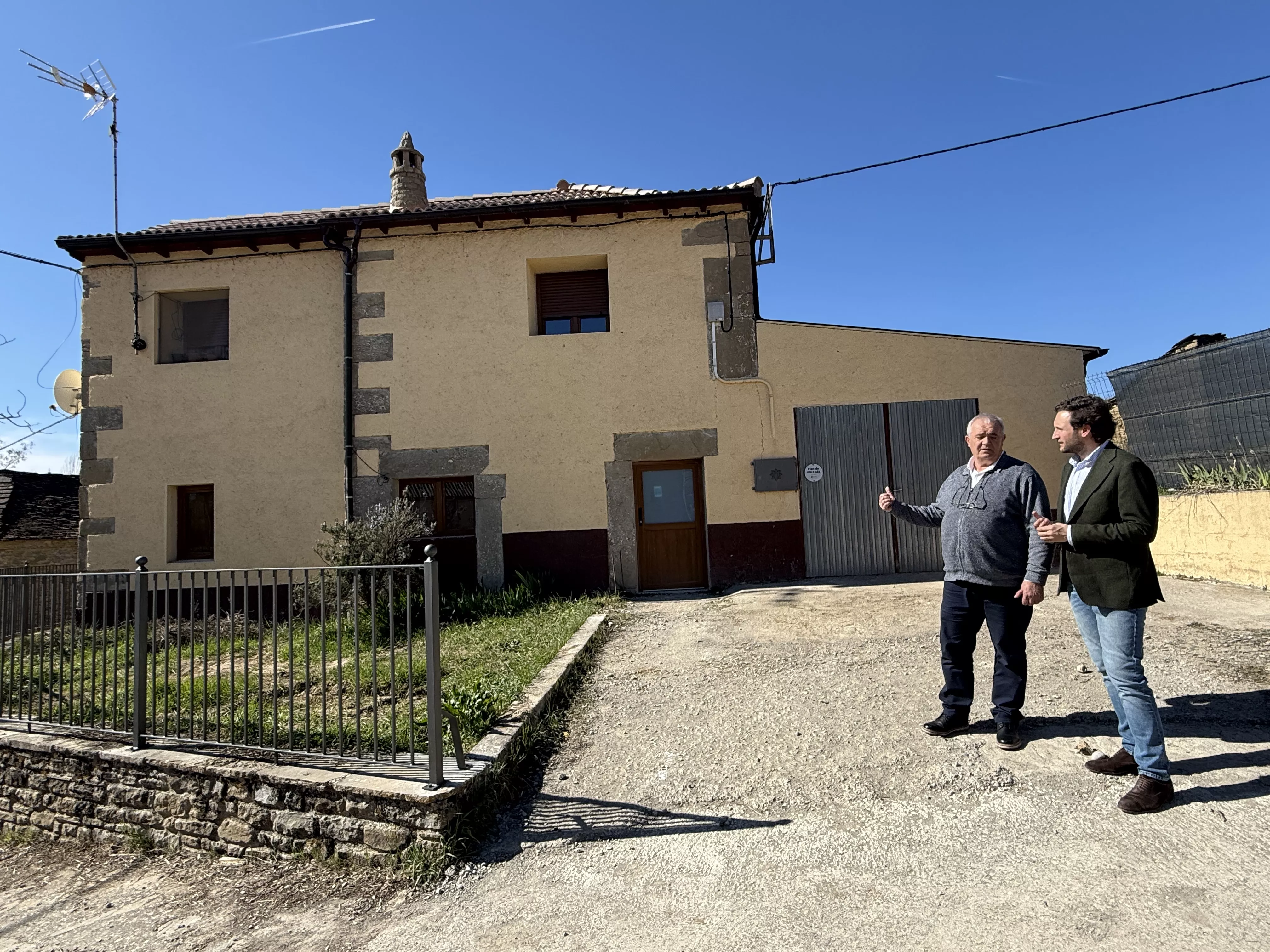 Isaac Claver junto al alcalde de Caldearenas, Primitivo Grasa, junto a la vivienda rehabilitada.