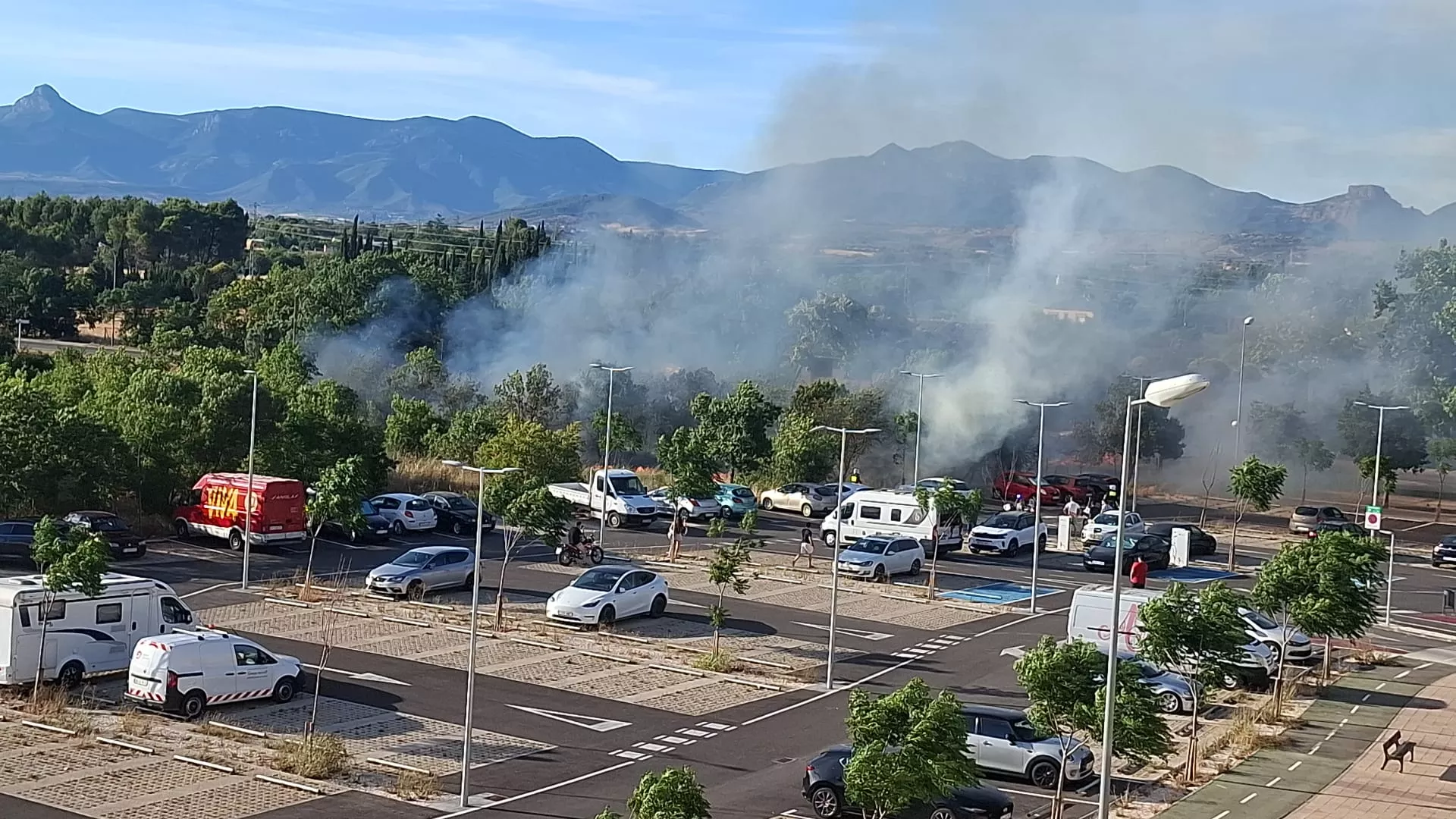 Los Bomberos de Huesca intervienen en un incendio de rastrojos junto al aparcamiento Pilar Lorengar.