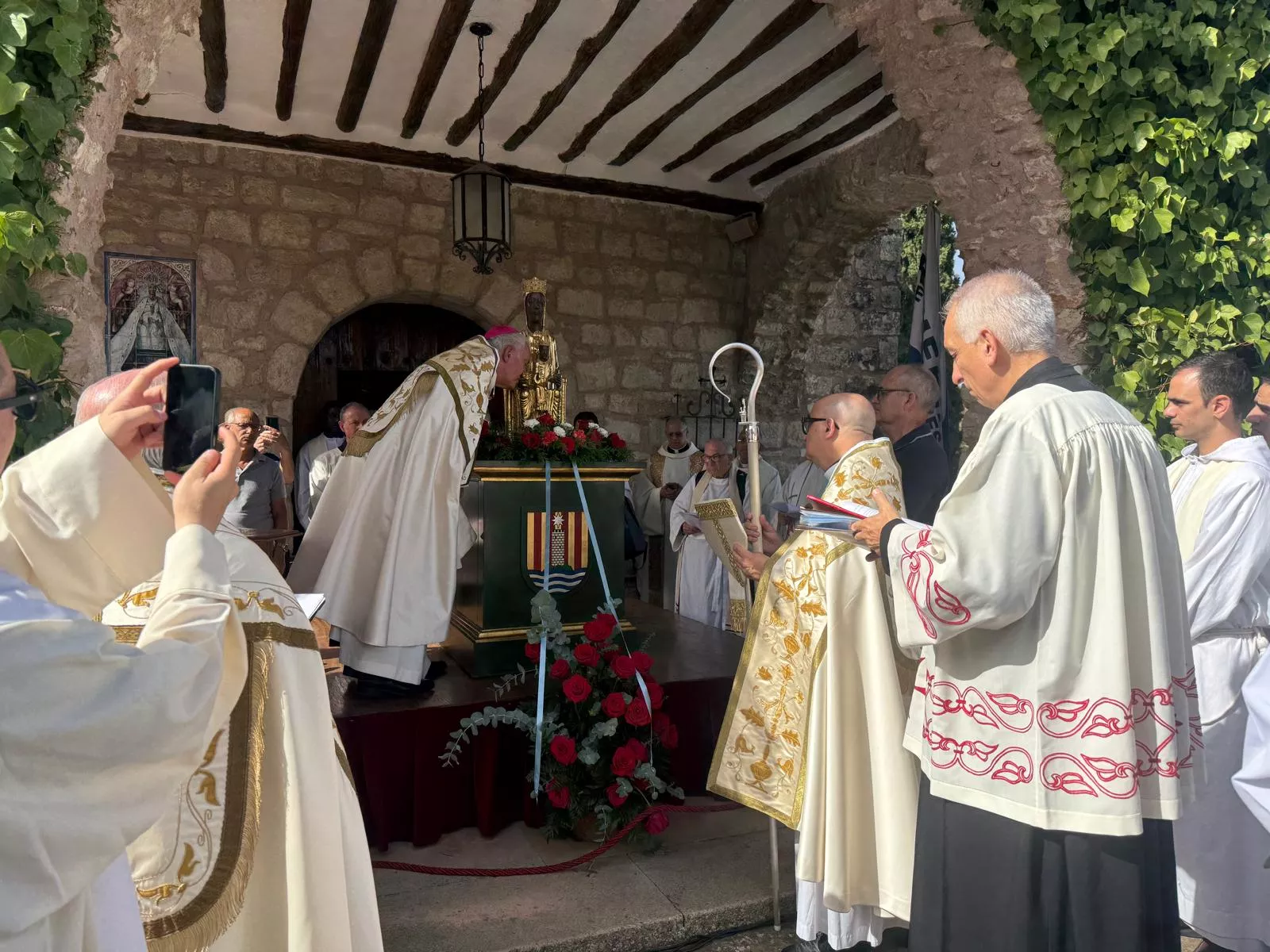 Monseñor Pérez Pueyo se agacha a adorar a la virgen de Torreciudad