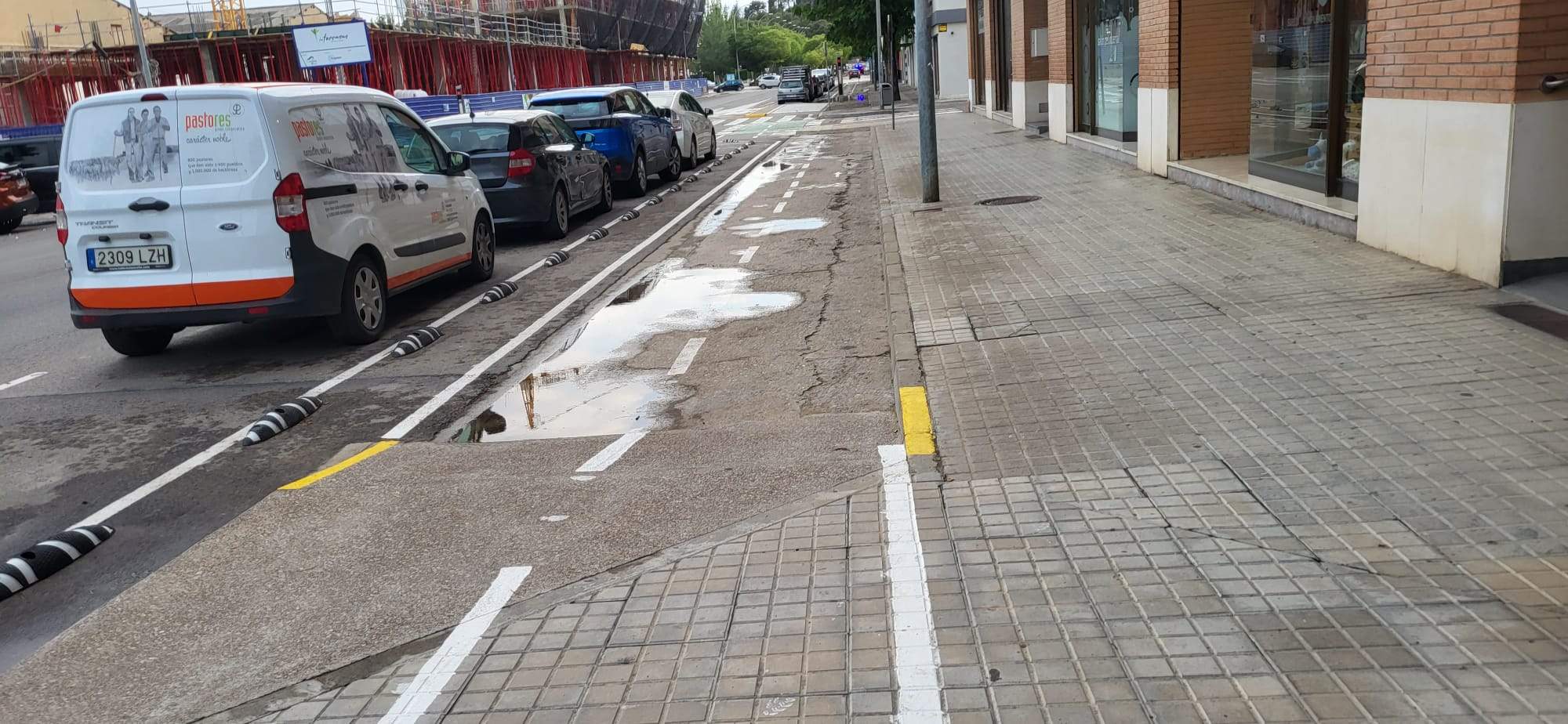 Tramo del nuevo carril bici en la calle San Jorge inundados tras la lluvia.
