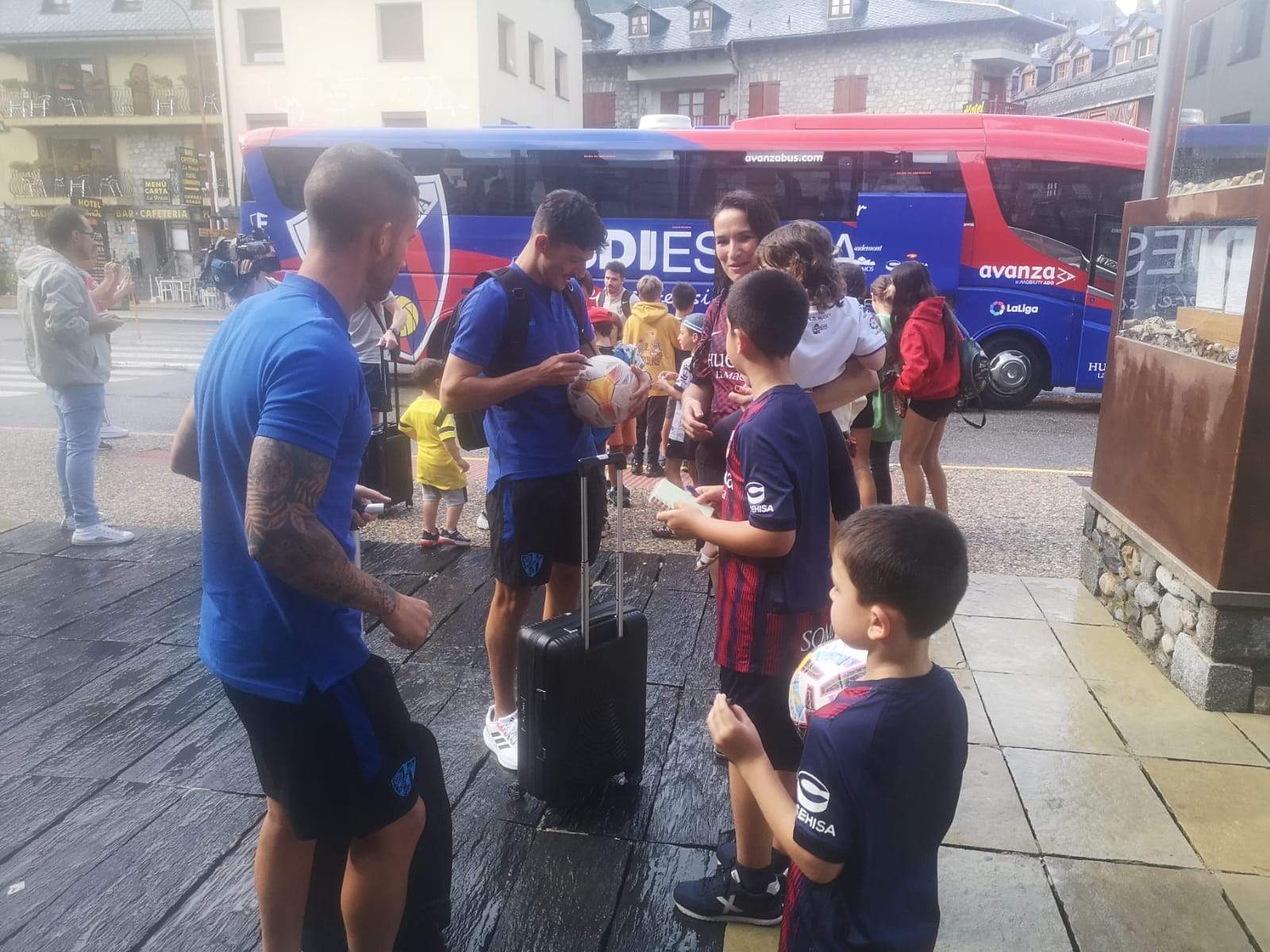 Jóvenes aficionados reciben al Huesca a su llegada a Benasque. Foto: Héctor Rodríguez